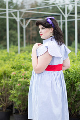 Young beautiful plus size Girl in greenhouse.