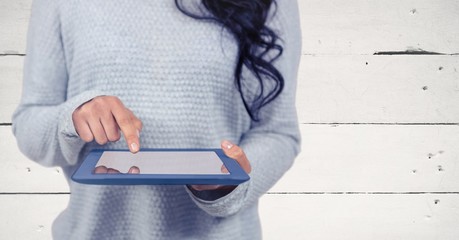 Woman mid section with tablet against white wood panel