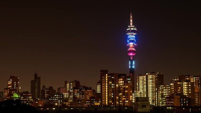 Static medium timelapse of the Hillbrow Tower / Telkom Tower (tallest building in JNB) over the city centre of Johannesburg at night with flickering lights of apartments and flats.