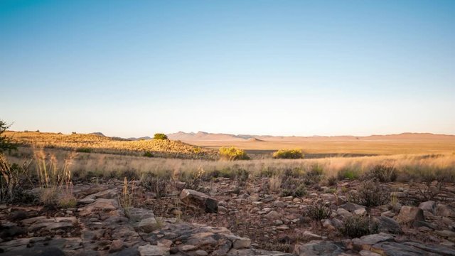A low angle linear timelapse of a typical Karoo landscape with vast open spaces and rolling hills at sunrise, South Africa available on request.