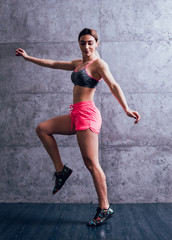 Fototapeta premium Young beautiful sportswoman doing exercises.