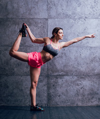 Fototapeta na wymiar Young beautiful sportswoman doing exercises.