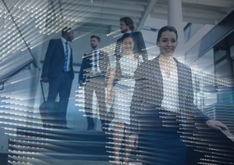 Business people walking down stairs with map graphic overlay