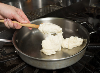 Preparing solid cheese in a pan, for Macaroni cheese