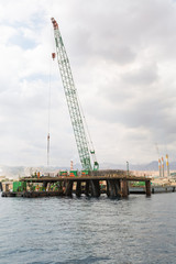 Aqaba, Jordan, 10/10/2015, Construction crane working on a jetty terminal at aqaba new port.