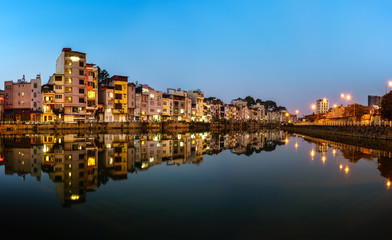Fototapeta na wymiar Resident houses and reflection on Tinh Bien lake in Hanoi, Vietnam