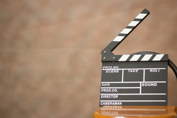 movie clapper with chair brown background