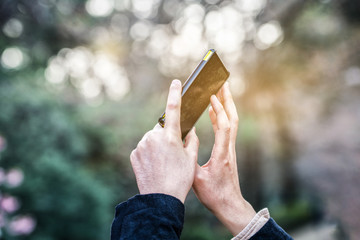 Hand of woman take a picture from smartphone, Blurred bokeh light in background