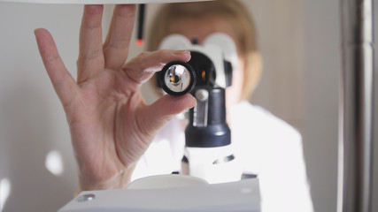 Healthcare - optometrist - doctor ophthalmology examining patient's eyes - medical concept