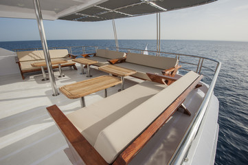 Table and chairs on deck of a luxury motor yacht
