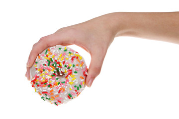 Young female hand holding one sprinkle donut isolated on white background