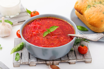 Traditional Ukrainian Russian vegetable borscht soup  on blue bowl.