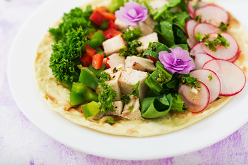 Healthy mexican corn tacos with boiled chicken breast, spinach, radish and paprika.