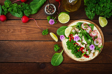 Healthy mexican corn tacos with boiled chicken breast, spinach, radish and paprika. Flat lay. Top view