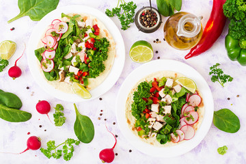 Healthy mexican corn tacos with boiled chicken breast, spinach, radish and paprika. Flat lay. Top view