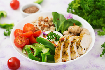 Diet menu. Healthy lifestyle. Oatmeal porridge,  chicken fillet and fresh vegetables - tomatoes, spinach, paprika,  mushrooms and yogurt  on plate.