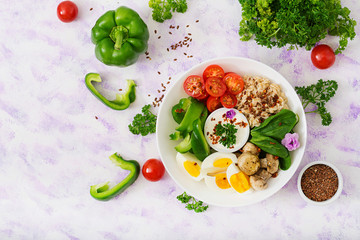 Diet menu. Healthy lifestyle. Oatmeal porridge, egg and fresh vegetables - tomatoes, spinach, paprika,  mushrooms and yogurt  on plate. Top view. Flat lay.