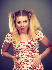 Funny teenage woman holding their stomach