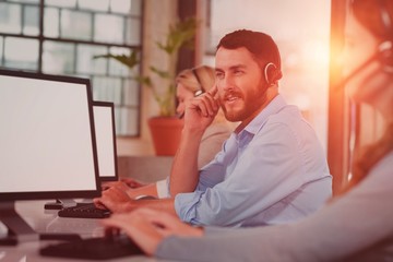 Thoughtful man working while sitting in office