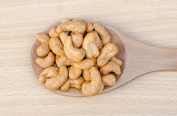 cashew nuts with salt on wood table
