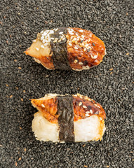Nigiri Sushi with Smoked Eel and Seaweed Nori on Dark Background