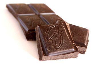 A few pieces of chocolate on a white background