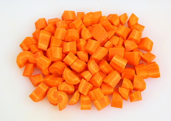 Chopped and sliced carrot on white plate
