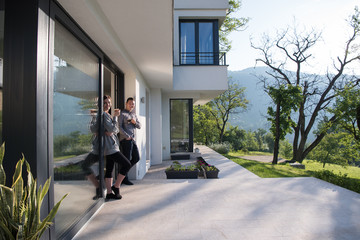Fototapeta premium couple enjoying on the door of their luxury home villa