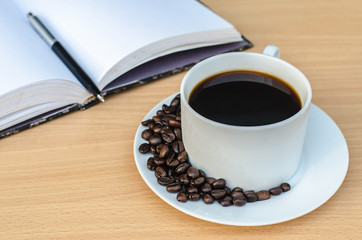 Open Notebook , Pen And Cup Of Coffee On Wooden Table.