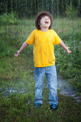 happy boy in rain summer outdoors