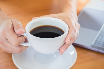 Hand On Hot Cup Of Coffee