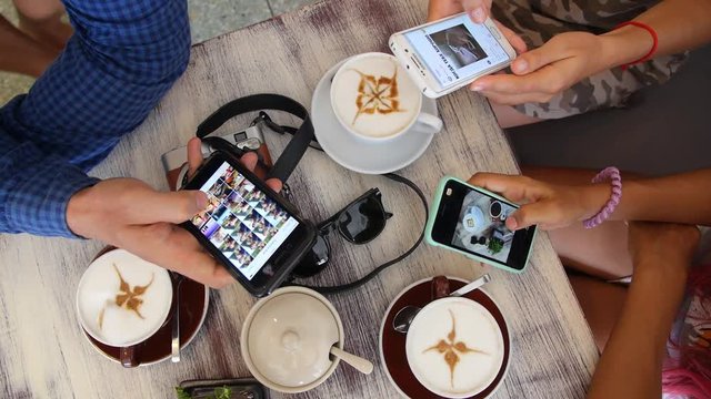 People Using Smart Phones in Cafe with Coffee