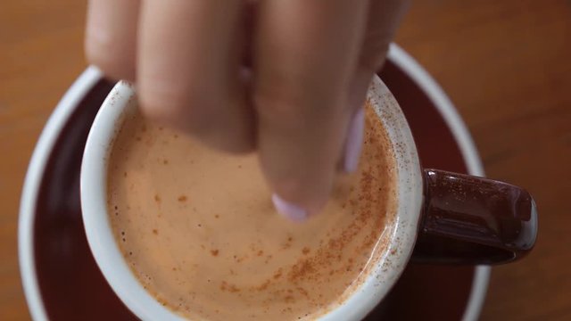 Stirring Cup of Hot Chai Latte with Spices in Cafe