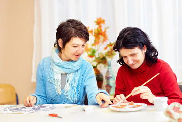 adult woman with special needs are engaged in handcraft in rehabilitation center