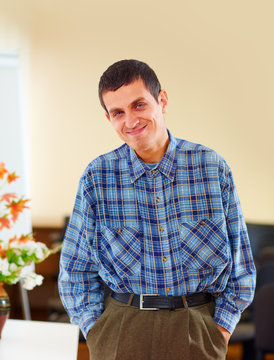 portrait of cheerful adult man with disability in rehabilitation center