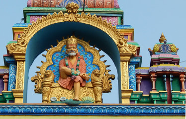 Idol of shirdi Sai Baba in sitting posture on the arch of temple