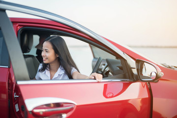 young woman happy and car in the park