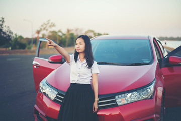 young woman happy and car red