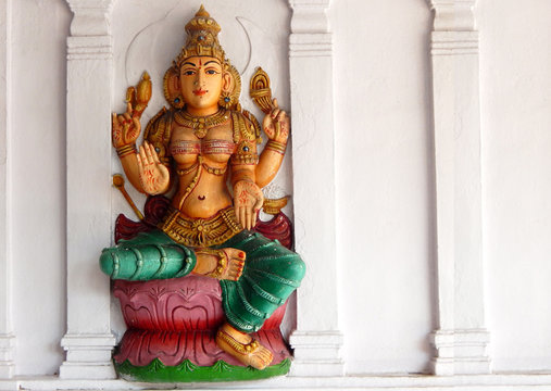Wall art of Hindu goddess lakshmi on the exterior of a temple 