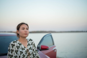 Fototapeta premium young woman sad and car at roadside and sunset time