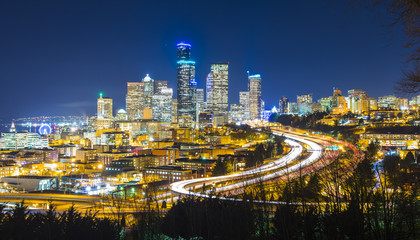 Fototapeta na wymiar Seattle cityscape at night with traffic light on freeway,Washington,usa.