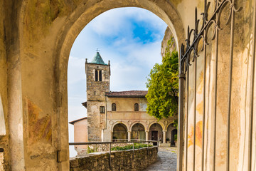 Fototapeta premium Hermitage of Santa Caterina del Sasso (XIII century) perched on a rocky ridge on lake Maggiore. The structure in photo is the church of Saint Catherine