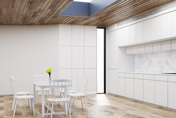 White kitchen with round table, wood