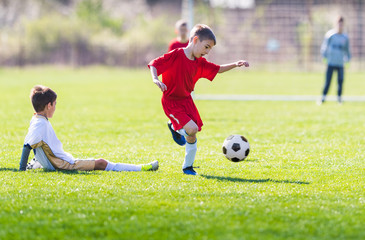 Kids soccer football - children players match on soccer field