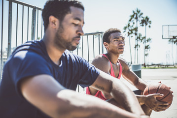 Naklejka premium Two basketball players playing outdoor in LA