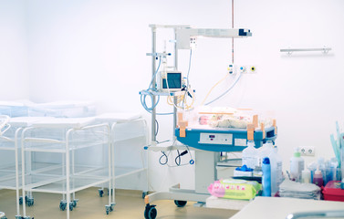 Newborn baby sleeping in an incubator in hospital.