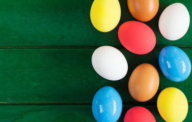 Colored eggs on wooden background, selective focus image. Happy Easter Card - space for text