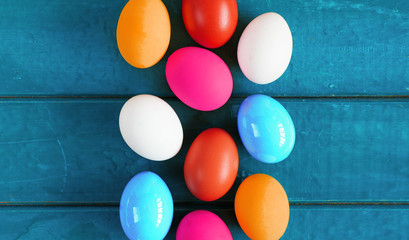 Bright colored dyed eggs on wooden