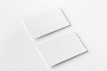 Mockup of two horizontal business cards at white textured background.