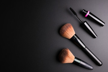 Set of flat top view of various professional female cosmetics brushes for makeup and eyelash brush isolated on black background, Cosmetics concept, Makeup concept, Copy space image for your text.